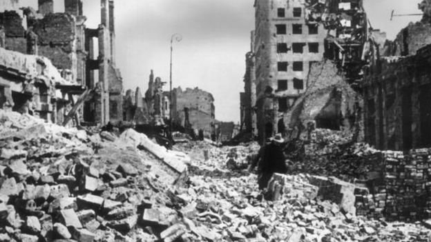A view of rubble and ruined buildings covering the streets after the German bombing of Warsaw, Poland.jpg