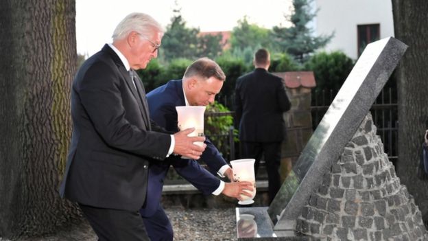 Steinmeier and Duda lit candles at a commemorative memorial.jpg